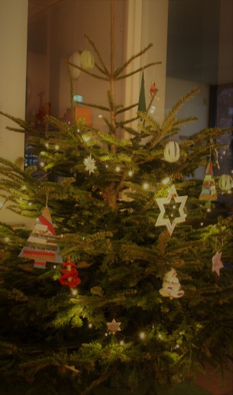 Ein geschmückter Weihnachtsbaum, der im Eingangsbereich steht.